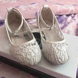 Little girls white lace shoes.